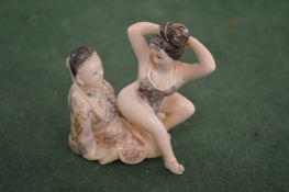 Two carved erotic figures.