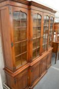 A large oak breakfront cupboard bookcase.