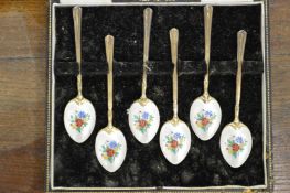A set of six silver and enamel backed coffee spoons.