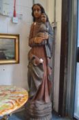 A large carved and painted wooden standing figure of Mary and the Infant Jesus.