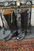 A pair of leather riding boots, size 7D.