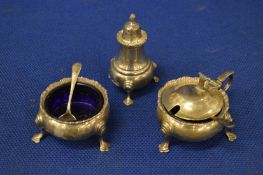 A silver three piece cruet set.
