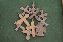 A group of bronze crosses.