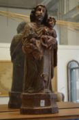 An 18th century Italian carved, gessoed and painted figure of Joseph and the Infant Jesus.