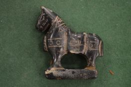 A carved stone model of a horse.