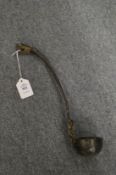 An archaic style bronze ladle.
