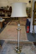 An ornate Adam revival floor standing lamp with shade.