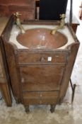 A mahogany wash basin containing a copper bowl with brass taps (AF).