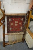 An unusual part made Persian rug on a loom.