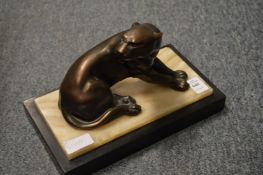 An Art Deco spelter model of a panther on a rectangular marble base.