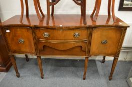 A serpentine fronted sideboard.
