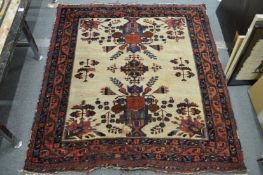 An unusual cream ground Persian rug.