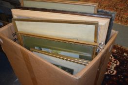 A box of paintings and prints.