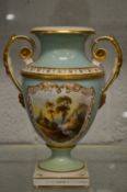 A porcelain twin handled pedestal vase painted with a river landscape.