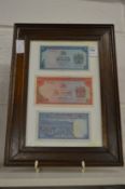 Three framed banknotes.