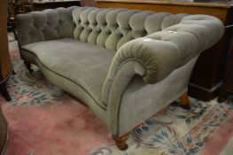 A good Victorian Chesterfield style serpentine fronted settee, the castors stamped C. Hindley &