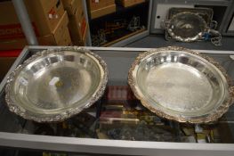 A pair of plated serving dishes with glass liners.