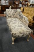 A small chaise longue together with a matching upholstered ottoman and bedroom chair.
