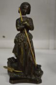A good small bronze figure of a women with a dog by her side.