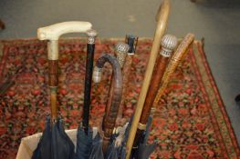 A good collection of parasols, some with silver handles (canopies AF).