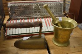A brass pestle and mortar and an early iron.