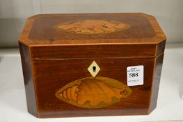 A Georgian mahogany tea caddy with shell inlaid decoration.
