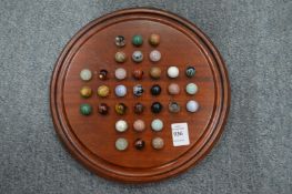 A solitaire board and some early marbles.