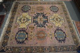 A Persian pink ground carpet.