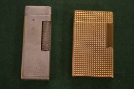 A Dupont lighter and a Dunhill lighter.