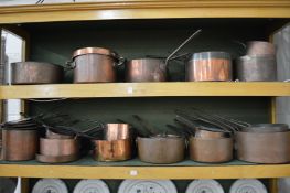 A comprehensive collection of Victorian copper saucepans, cooking pots etc.