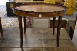 An oval mahogany tray table.
