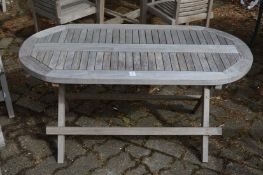 A small hardwood folding oval garden table.