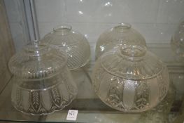 Four cut glass lampshades.