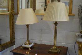 Two Corinthian column style table lamps.