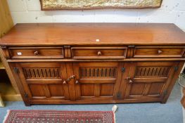 A reproduction oak sideboard.