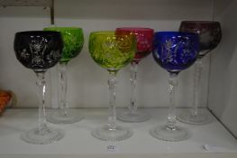 Six coloured hock glasses.