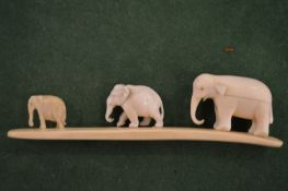 Three carved elephants.