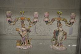 A good pair of porcelain figural twin branch candelabra.