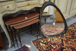 A nest of tables and a wall mirror.