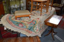 A large cream ground oval floral decorated rug.