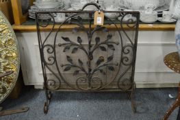 A heavy wrought iron fireguard.