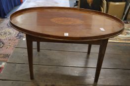 A mahogany and inlaid oval tray table.