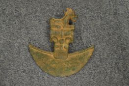 An archaic style bronze axe head mounted on a later stand.