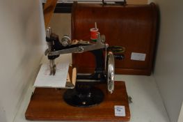 A miniature sewing machine.