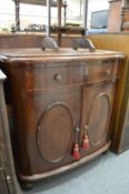 A mahogany bow front cupboard with two drawers.