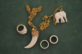 An elephant pendant on a gilt metal chain and other jewellery.