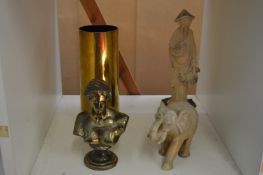 A brass shell case, decorative ornaments.