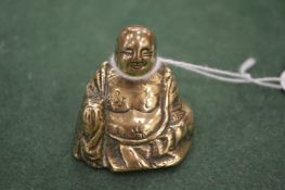 A miniature bronze Buddha.