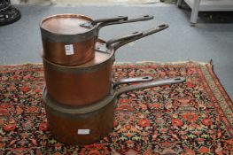 A good set of three Victorian copper saucepans with lids.