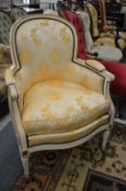 A French style cream painted and upholstered armchair.